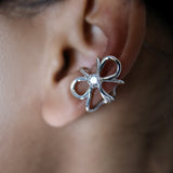 Ear cuff Intuition en argent 925, fleur serti de pierres d'intention, détail porté moissanite — Collection Éclosion